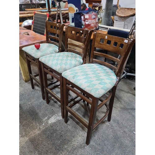 1031 - A set of three well crafted bar stools with carved backrests, foot rests with brass protectors and p... 