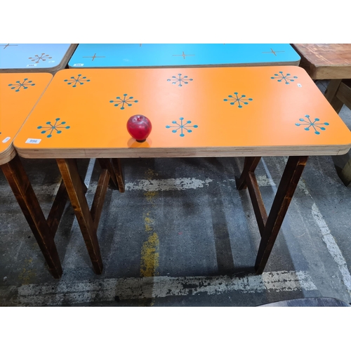 996 - A very stylish dining table with a vibrant orange top featuring a star pattern, held on robust woode... 