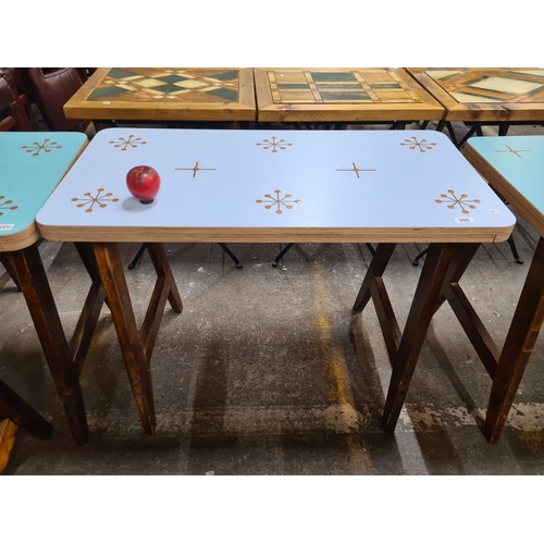 998 - A very stylish dining table with a duck egg blue top featuring a star pattern, held on robust wooden... 