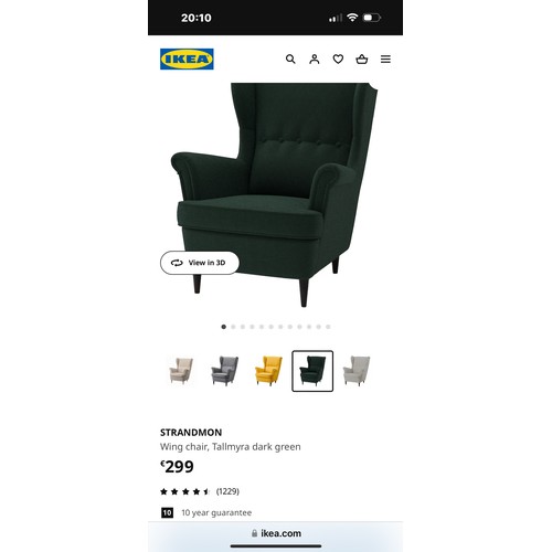 927 - Star Lot : A sophisticated wingback armchair with forest green upholster and elegant buttonback deta... 