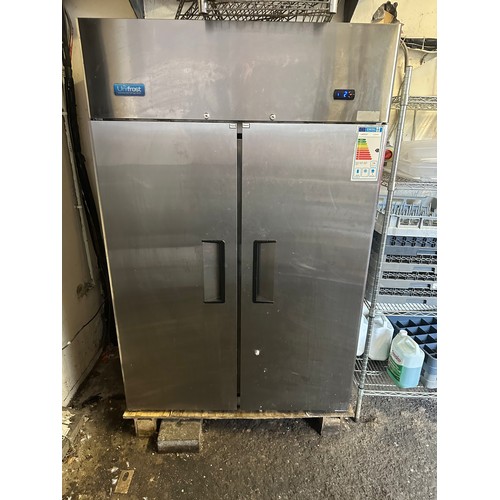 1048 - Star Lot : A large double door Unifrost Stainless Steel Fridge with 3 white racks inside. Fully work... 