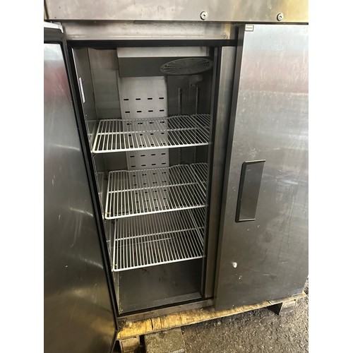 1048 - Star Lot : A large double door Unifrost Stainless Steel Fridge with 3 white racks inside. Fully work... 