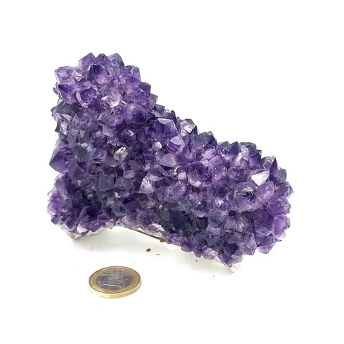 412 - A block of natural bright purple amethyst stones, weight 615 grams. Retail price €200