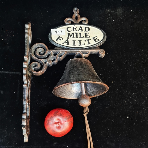 117 - A charming cast metal bell with an ornate foliate wall bracket and an Irish welcome plaque.