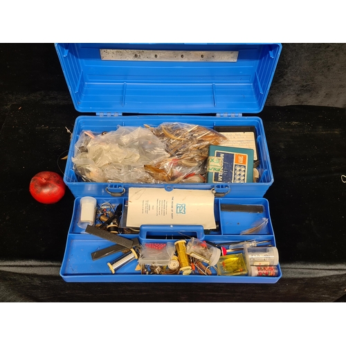 193 - A fishing box containing a large selection of fishing tackle including feathers and floats.