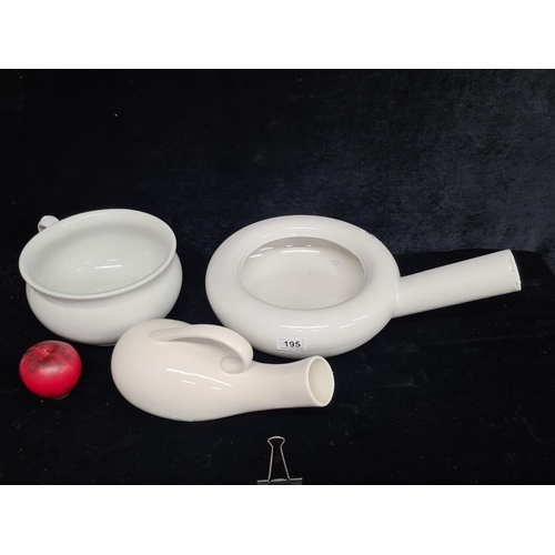 195 - A trio of bedside enamelware including a large chamber pot, bed pan and urinal cup.