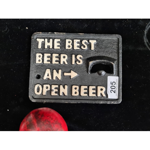 205 - A humorous cast metal wall mounted bottle opener.