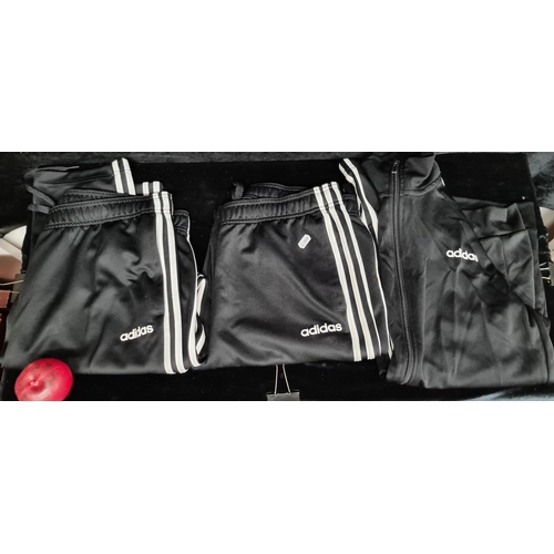 233 - An Adidas black and white tracksuit including zip jacket (size children's US L) and bottoms along wi... 