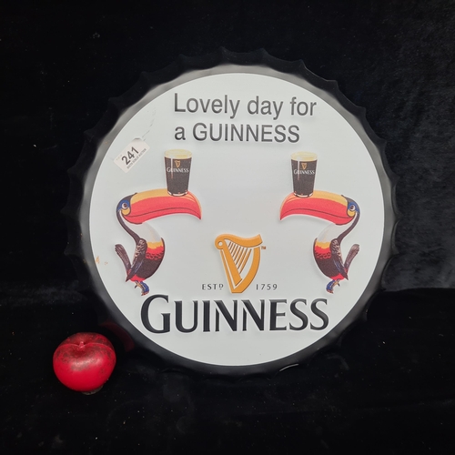 241 - A large metal Guinness advertising pub sign in the form of an oversized bottle cap.