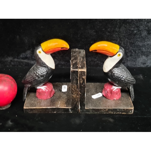 256 - A charming pair of cast metal Guinness toucan bookends.