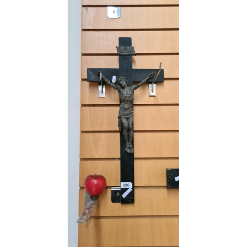 286 - A large antique wooden crucifix with cast metal detailing.