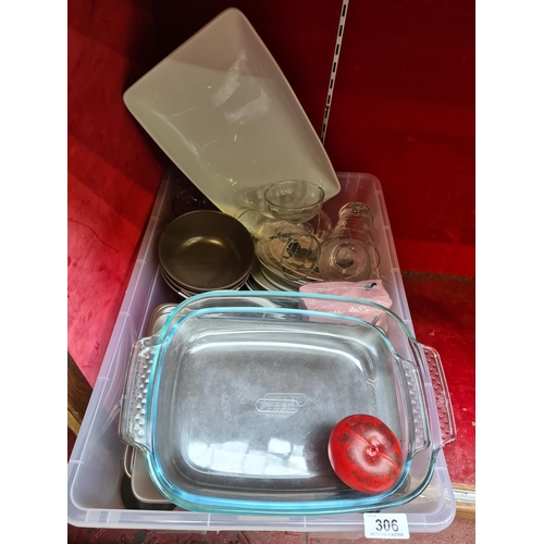 306 - A large box containing an assortment of kitchen and dining ware including cups, pyrex, glasses, plat... 