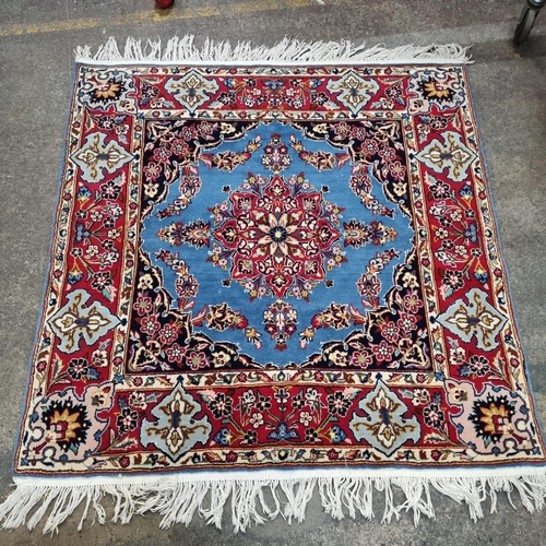340 - Star Lot : A Persian style hand knotted wool rug boasting a floral and geometric pattern in shades o... 