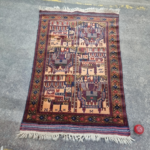 349 - A charming neatly sized hand knotted woollen rug with a geometric pattern in rich shades of red, nav... 