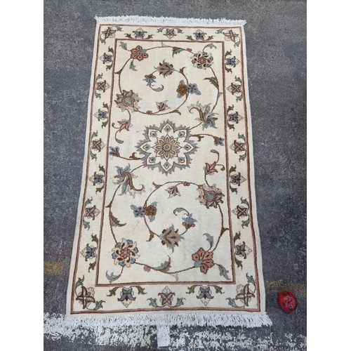 350 - A pretty neatly sized woollen rug with a delicate floral pattern in shades of cream, blue and peach.... 