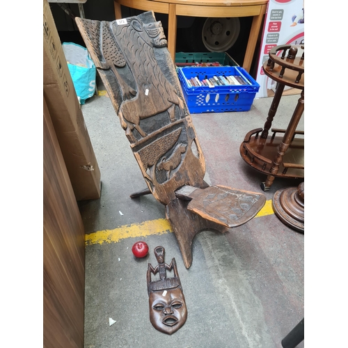 373 - A stunning hand carved African wooden birthing chair. Features beautiful lion and elephant carvings ... 