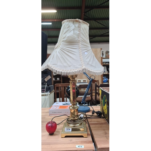 379 - A very elegant high quality table lamp with an ornate brass stem and topped with a cream pleated sha... 