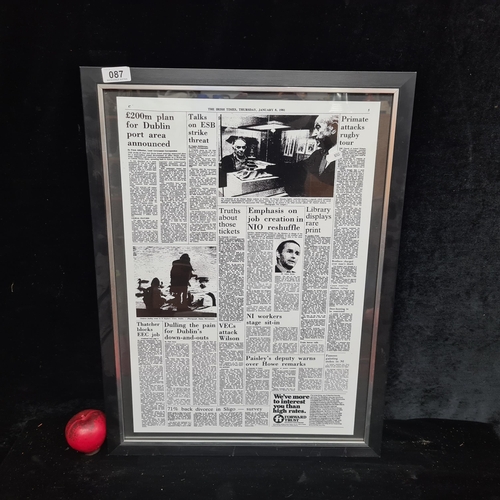 87 - A print from page 5 of The Irish Times, January 1981. Housed in a black and chrome frame behind glas... 