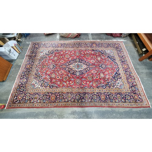 663 - Star Lot L A beautiful large hand knotted Persian  woollen rug boasting an intricate foliate design ... 