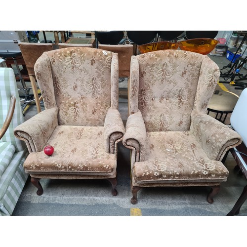 388 - A pair of vintage wingback armchairs with solid wood frames and cabriole legs. Very comfortable clas... 