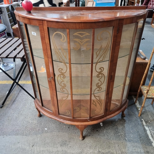 578 - A gorgeous circa 1930's bow fronted display case with design to front panel and a velvet back.