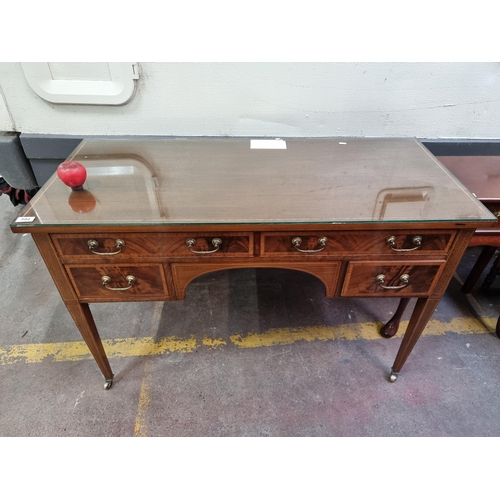 594 - Star Lot : A fabulous Edwardian writing table with four drawers boasting brass swan neck handles, be... 