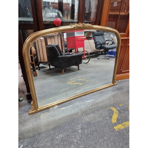 597 - Stat Lot : A gorgeous large gilt over mantle mirror in a French style with beveled glass. 130cm x 10... 