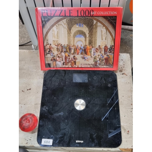 604 - Two items including an unopened 1000 piece jigsaw puzzle from the Art Collection and a Withings elec... 