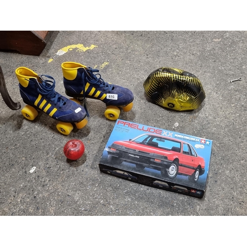 610 - Three items including a pair of retro roller skates, a size 5 football, a Honda Prelude model car br... 