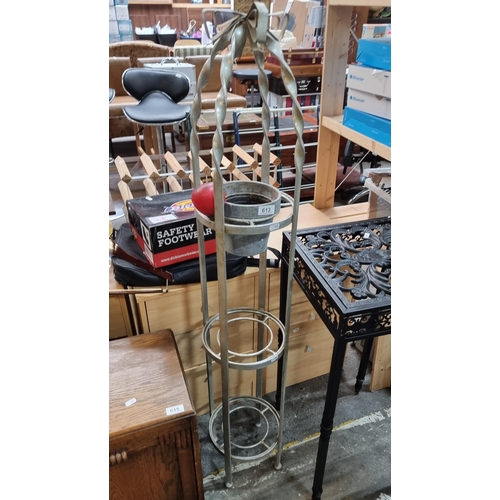 613 - A superb three tier cast metal plant stand with a bow finish.