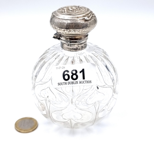 681 - An antique cut glass sterling silver topped perfume  bottle, hallmarked Birmingham. Lid set with att... 