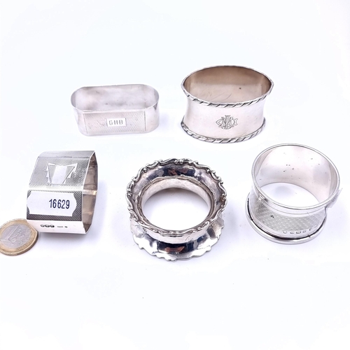 685 - A collection of five assorted napkin rings including four silver examples, total weight of silver 34... 