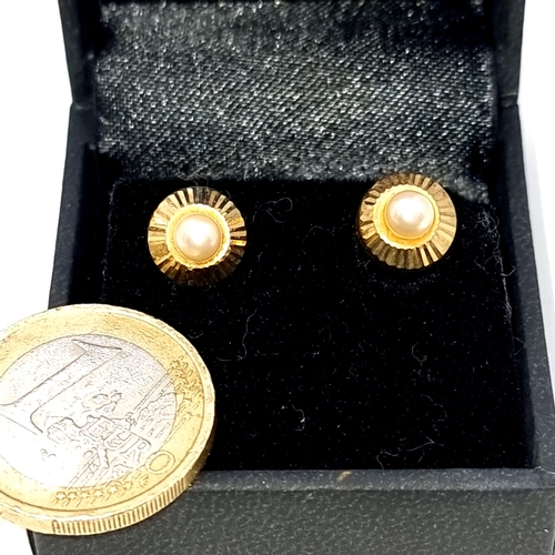 695 - A pair of 9K gold pearl stud earrings, total weight 1.38 grams, boxed.