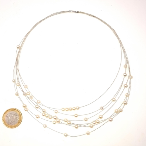 702 - A six strand natural pearl string necklace, length 42cm, set with amn 18k gold white bayonette clasp... 