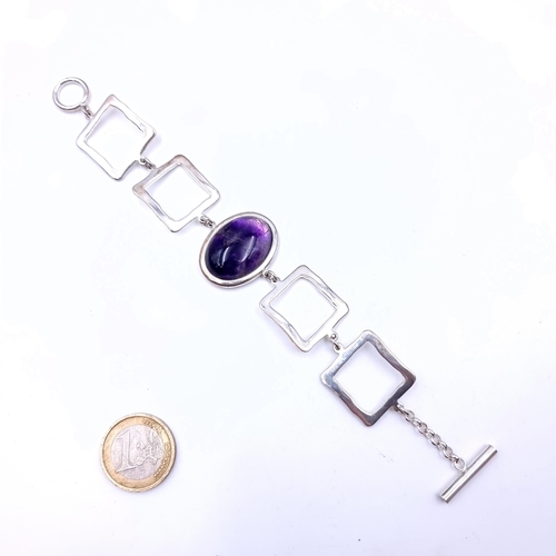 709 - A good example of a sterling bracelet featuring a cabochon amethyst stone mount set with t-bar clasp... 