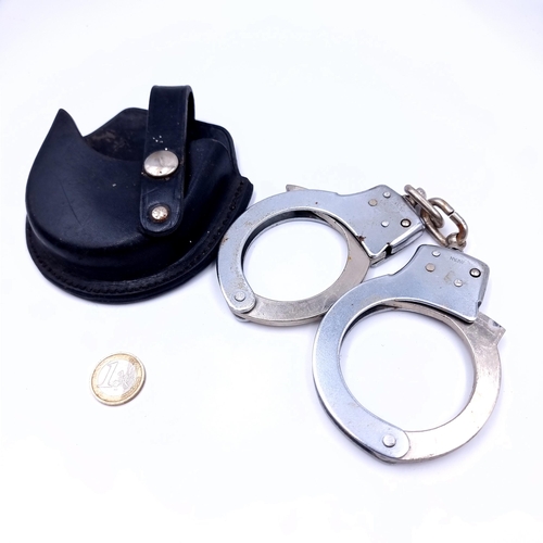 731 - A pair of handcuffs marked Japan with leather pouch. (Without key).