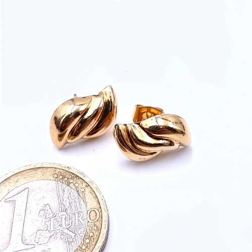 732 - A pair of  9k gold stud earrings, marks to posts, total weight 1.19 grams.