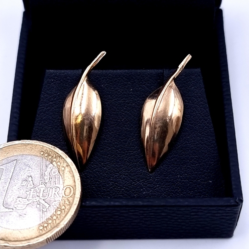 733 - A pair of  9K gold leaf design stud earrings, marks to posts, total weight .8 grams.