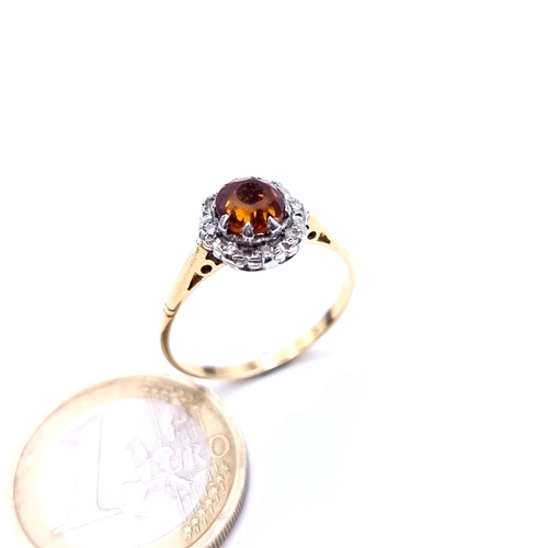 737 - A 9K gold topaz gemstone ring set with diamond cluster surround, ring size Q, weight 2.8 grams, boxe... 