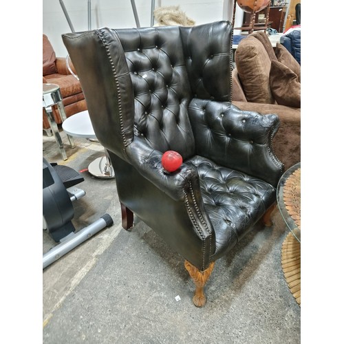 644 - Star Lot: A very handsome vintage leather wingback armchair in the Chesterfield style. Features butt... 