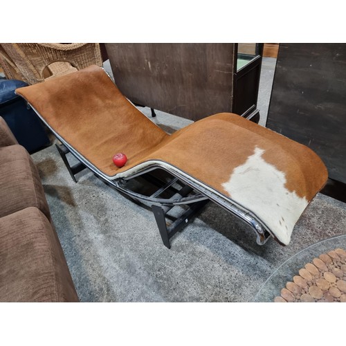 651 - Star Lot: An Iconic LC4 Le Corbusier cow hide lounge chair. Features a chrome tube frame to complete... 