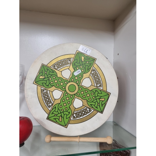 775 - A traditional Irish bodhran drum with genuine hide drumhead, Celtic knot motif and beater.