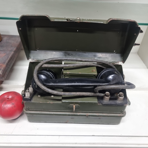 783 - An original vintage military British army field telephone held in its original metal case.