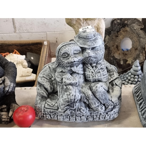 854 - An endearing and heavy reconstituted stone garden sculpture of two woodland creatures curled up on a... 