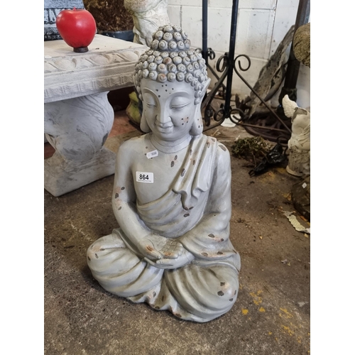 864 - A stylish and heavy reconstituted stone garden sculpture of a seated Thai Buddha figure, in a grey p... 