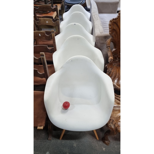 906 - A set of six contemporary Eames style tub chairs with fresh white seats and tapered pine wood legs, ... 