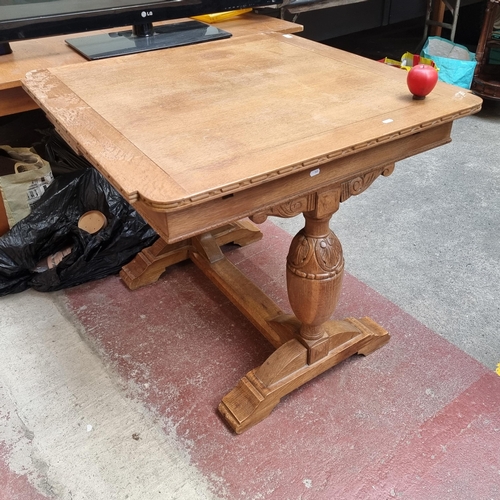 911 - A handsome oak breakfast dining table with ornately carved supports featuring a foliate design. The ... 