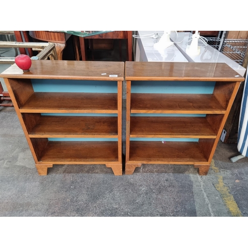 912 - An adorable pair of vintage mid century G plan bookcases, each with two shelves, striking blue backi... 