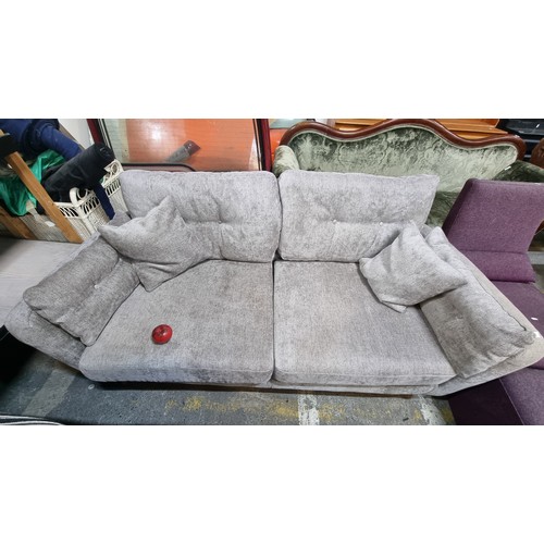 633 - A stylish and extremely comfortable two seater sofa upholstered in a sleek grey fabric and with two ... 