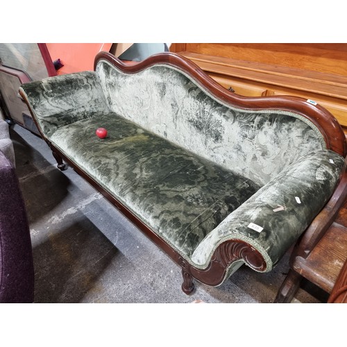 635 - Star lot : A lavish antique three seater sofa with rolled armrests and newly recovered in green sati... 